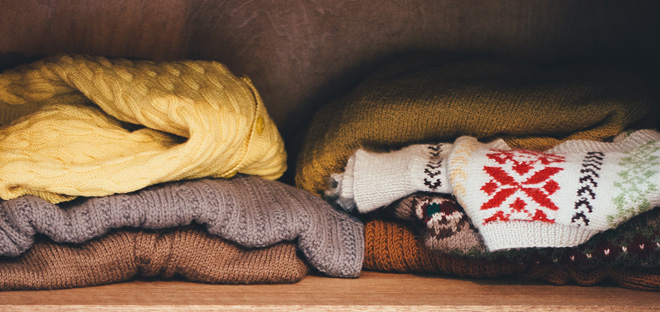 Jumpers folded in a wardrobe